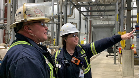 Kara Zernhel, Cenovus Lima Refinery Manager, Area Operations, and Operator, Chris Brooks make an adjustment in the water re-use process, placing a softener into regeneration.
