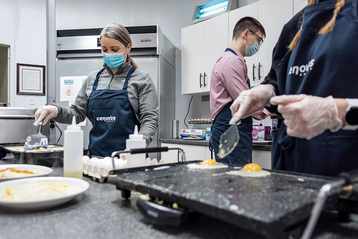 Cenovus employees Pam Stone and Earl Reid get a nutritious and hot breakfast ready for members of their community.
